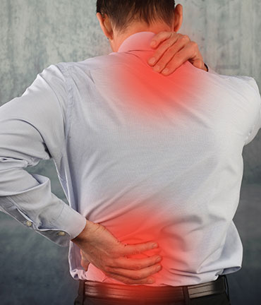 Man suffering lower and upper back pain after an auto accident