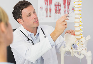 Chiropractor explaining chiropractics to patient